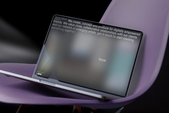 Laptop on purple chair showcasing blurred website design, ideal for mockups, digital asset, web template, user interface, modern display.